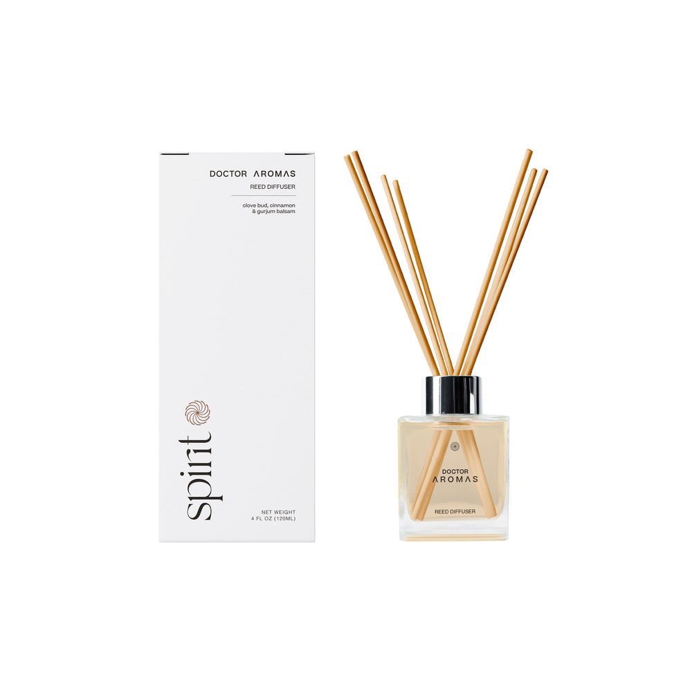 Clear square glass reed diffuser bottle with black cap and natural reeds next to tall white box labeled Spirit and Hope scent.
