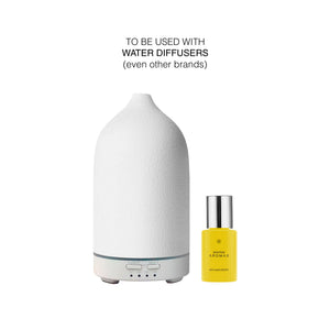 White ceramic ultrasonic diffuser with digital controls next to a small yellow bottle of Hope diffuser drops. - Diffuser Drops | Hope - Hope - Doctor Aromas