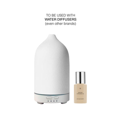 White ceramic water diffuser with digital controls next to a small beige diffuser drops bottle labeled Holiday. - Diffuser Drops Twin Pack | Holiday - Holiday - Doctor Aromas