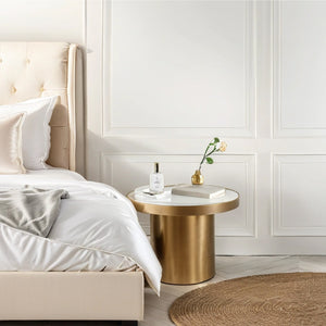Small clear glass bottle with black spray cap labeled Hope on a gold round side table beside a beige upholstered bed with. - Pillow & Body Mist | Hope - Default Title - Doctor Aromas