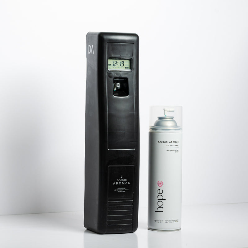 Black vertical A/C scenting system unit with digital screen and white aerosol canister labeled "Hope 8" blush scent next to. - A/C Scenting System Pro | Blush - Blush - Doctor Aromas