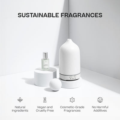 White ceramic aromatherapy stone diffuser with smooth matte finish and rounded top, next to matching essential oil bottle. - Aromatherapy Stone Diffuser | Holiday - Holiday / White - Doctor Aromas