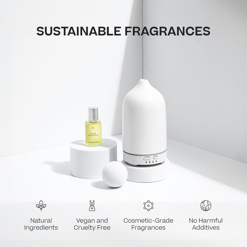 Blush aromatherapy stone diffuser with smooth matte finish next to white essential oil bottle and stone on white pedestal. - Aromatherapy Stone Diffuser | Blush - Blush / White - Doctor Aromas