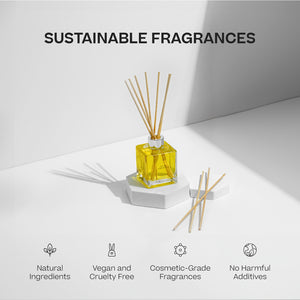 Yellow oil reed diffuser in a clear square glass bottle with natural wooden reeds on a white hexagonal platform. - Oil Reed Diffuser | Hope - Hope - Doctor Aromas