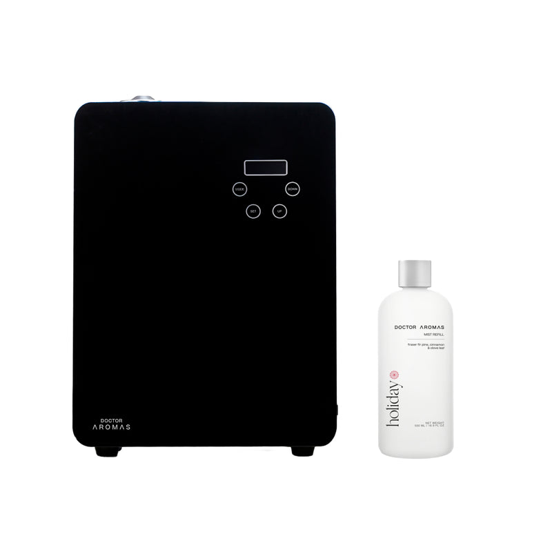 Black rectangular aroma diffuser with digital controls paired with a white fragrance bottle.