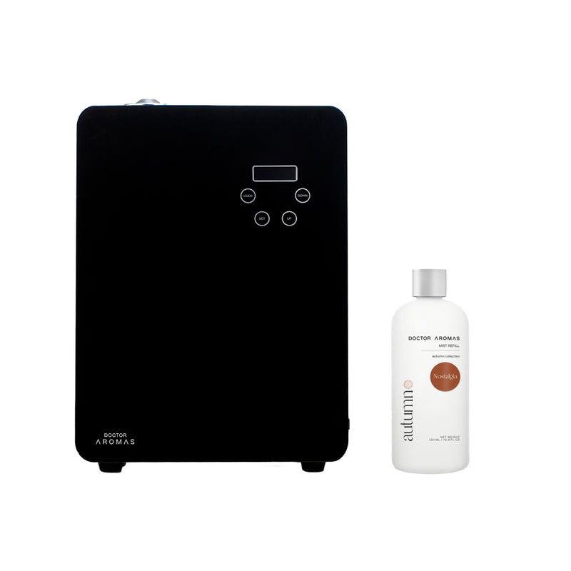 Black rectangular aroma diffuser with digital display and white fragrance bottle labeled "Caribbean Breeze".