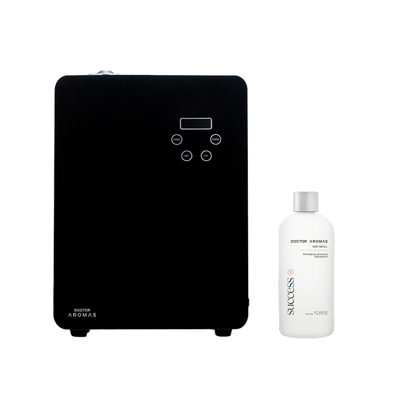 Black aroma diffuser with digital display and control buttons beside white scented oil bottle labeled Success.