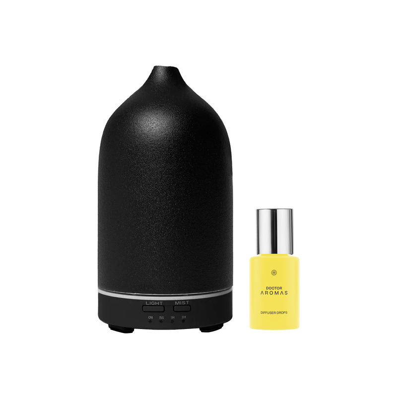 Matte black stone diffuser with rounded top and silver base, paired with small yellow essential oil bottle. - Aromatherapy Stone Diffuser | Blush - Blush / White - Doctor Aromas