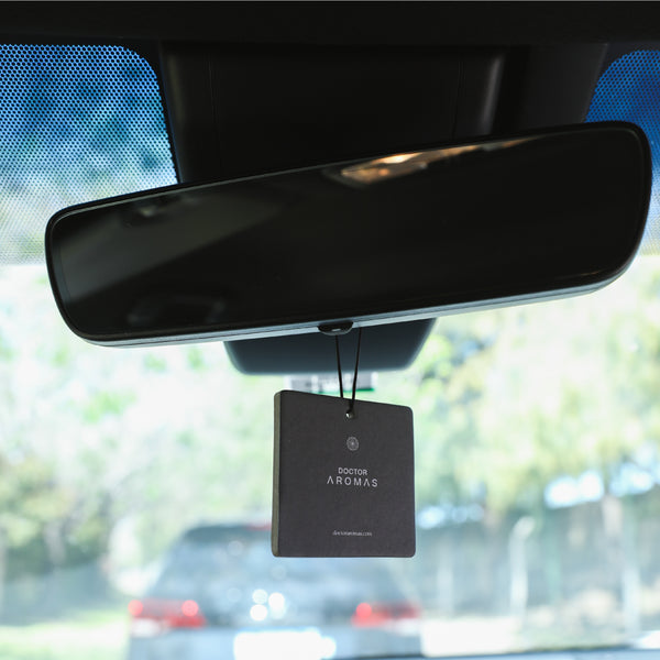 Black square car perfume hanging from rearview mirror with minimal white text design. - Car Perfume x4 Bundle | Holiday - Holiday - Doctor Aromas