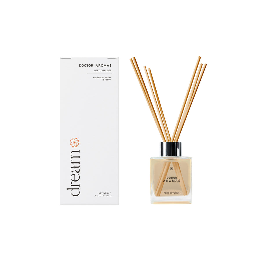 Square clear glass oil reed diffuser with natural wooden reeds and white box packaging labeled "dream".