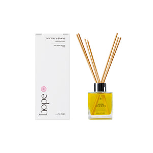 Square glass oil reed diffuser with yellow liquid and black cap beside white rectangular box labeled Hope. - Oil Reed Diffuser | Hope - Hope - Doctor Aromas
