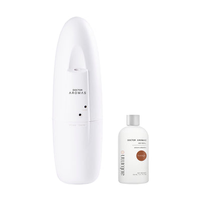 White sleek plug-in diffuser with smooth curved design next to a small fragrance refill bottle labeled Driftwood. - Plug-In Diffuser | Nostalgia - Nostalgia - Doctor Aromas
