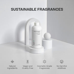 White cylindrical bottle of mist refill with minimalistic label, placed on white pedestal with curved arch backdrop. - Mist Refill | Spa - Spa / 100 ml - Doctor Aromas