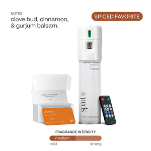 White Doctor Aromas A/C spray dispenser with green indicator, orange spiced scent box labeled Spirit, and black remote. - Doctor Aromas A/C Scenting System - A/C Spray Dispenser with Remote Control, Customizable Scent Experience, Vegan & Cruelty-Free, 17.1 oz Fragrance Oil, Whole Home Freshener, Battery Operated, Non-Toxic, Cosmetic Grade Scents - Hope® - Doctor Aromas